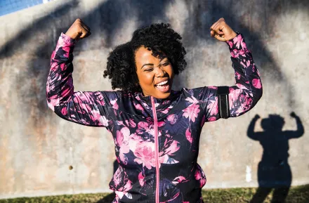 Mom shows her muscles, celebrating her health and wellness New Year's resolution