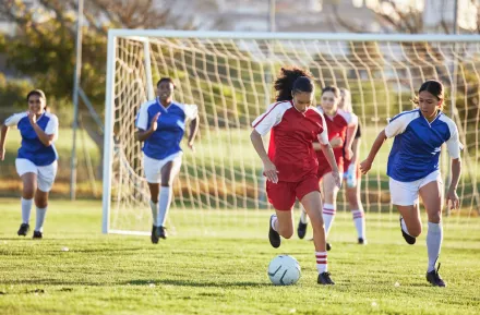 Young women playing soccer in the spring and are injury-free