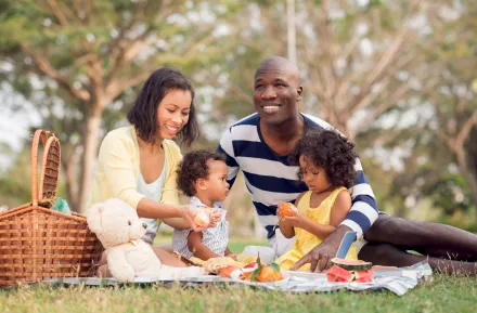 a family with a child enjoys a Pacific Northwest picnic in the park