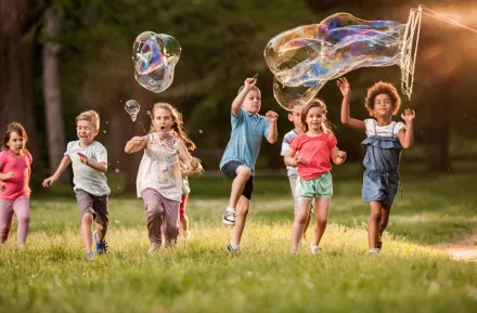 Kids playing outside with bubbles enjoying free family fun near Seattle