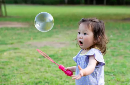 A toddler girl playing outside in the park enjoying free things to do in Seattle