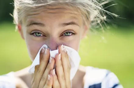 girl sneezing who has environmental allergies and needs immunotherapy