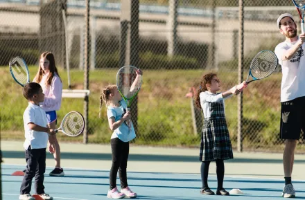 Kids playing tennis at Bear Creek school 