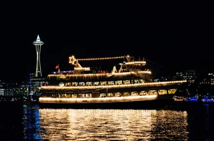 Argosy Christmas cruise ship on Elliot Bay with a view of the Space Needle, a fun Seattle holiday tradition for families