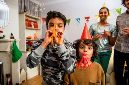 Family with two boys with blowers celebrating new years eve events in Seattle