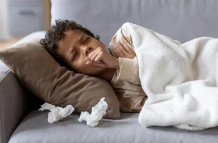 Boy resting on the couch home sick from school