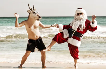 santa dancing with a reindeer on the beach