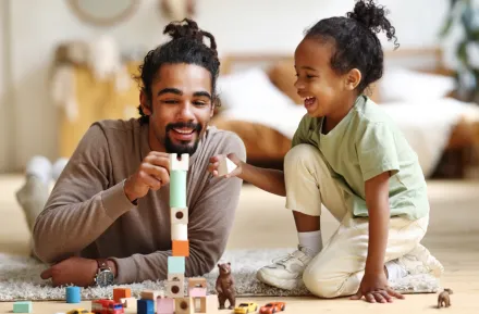 dad playing on the floor with his child