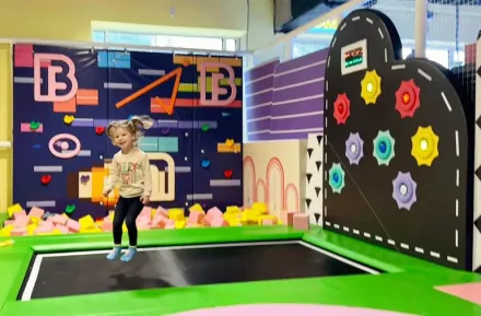 little kid jumping on trampoline during an indoor birthday party near Seattle