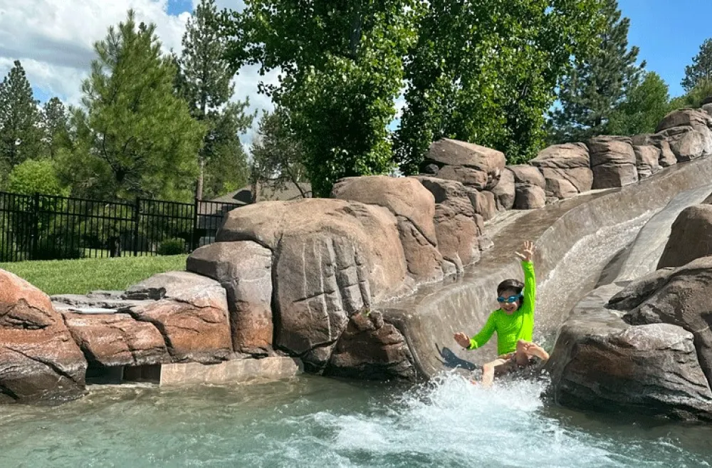  Young child slides down the waterslide at Sunriver Resort in Sunriver, Oregon