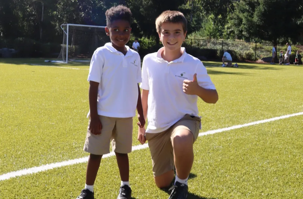 Two boys on a field at St. Thomas school