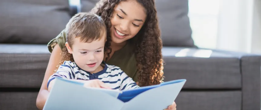 Teenage babysitter reading a book with a child how much to pay your babysitter