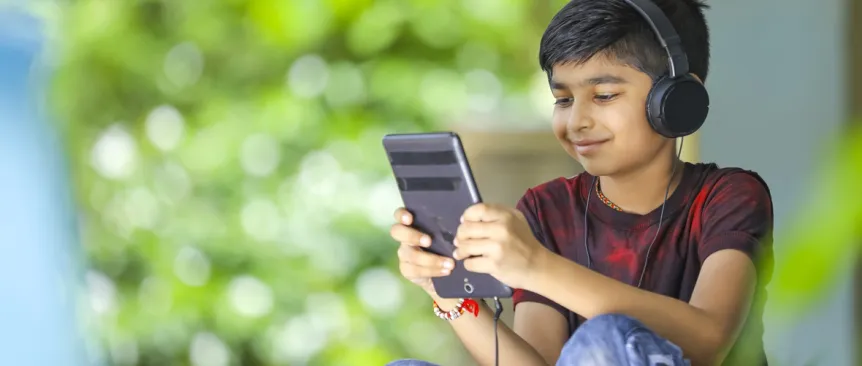 Young boy wearing headphones using an education app