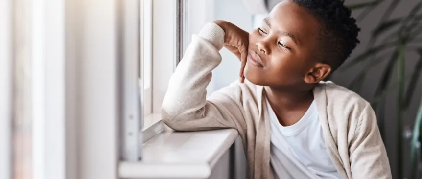 boy looking out a window