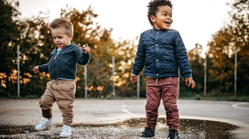 little kids playing in the rain at a park