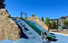 Young kids climb up the climbing mound at a new park in Duvall, one of the many things to do this weekend in Seattle