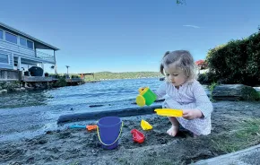 Little girl playing at a secret beach in Seattle