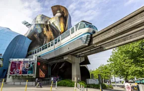 The Seattle Monorail on its track outside of MoPOP at Seattle Center, one of the best train adventures for families