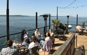 Families enjoying a meal at Duke's, a waterfront restaurant in Tacoma