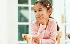 a thoughtful child looks to the side as she builds memory skills