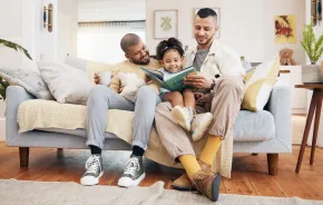 dads and child reading a book together during banned books week