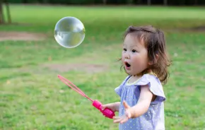 A toddler girl playing outside in the park enjoying free things to do in Seattle