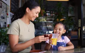 Mom and daughter in a coffee shop having special drinks together