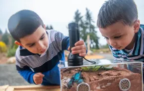 Two kids at Bugs Alive!, a Seattle-area insect encounter at Point Defiance Zoo and Aquarium