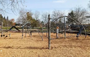 Young kid climbs on a rope bridge at a Seattle playground, on of the many things to do this weekend