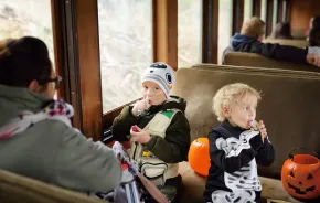 Two kids enjoying a Halloween train ride near Seattle, a fun fall activity for the whole family