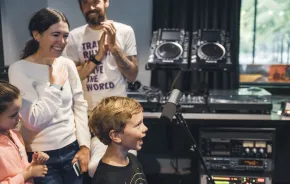 A young music fan takes the mic for Kids Day on the Morning Show at KEXP. Photo: Melissa DeAun for KEXP