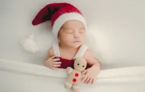 sleeping baby wearing a santa hat for a sweet and easy holiday photo