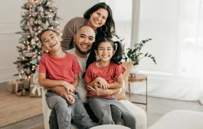 family smiling together for a holiday photo 