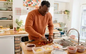 dad in a kitchen prepping lunches for the week