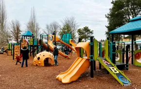 Family playing at Gene Coulon Memorial Park, a playground on the Eastside