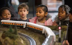 kids watching a model train at the Washington State History Museum, one of the many things for families to do this weekend near Seattle