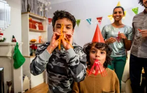 Family with two boys with blowers celebrating new years eve events in Seattle