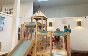 Young kids playing in the indoor play space at Holiday Cafe in Puyallup, a kid-friendly coffee shop