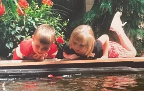 Max and Lucy Murrell looking at koi fish as chidlren