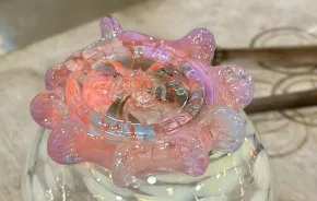 a monkeyshine cooling off over a glass of ice water