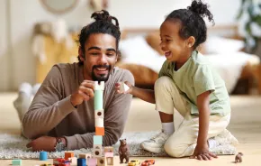 dad playing on the floor with his child