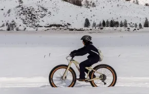 Kid riding a fat bike in the snow outside of Seattle in Methow Valley, a fun winter sport activity for families