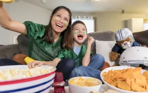 mom and son having fun watching the Super Bowl