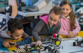 kids working on a robotics project at a mid-winter camp