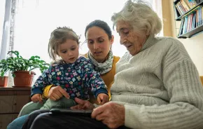 Grandma, mom and child sitting together