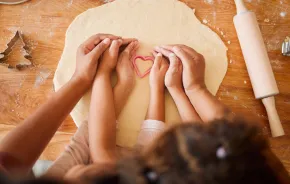 parent and child making valentine's day treats together