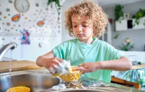 child washing dishes